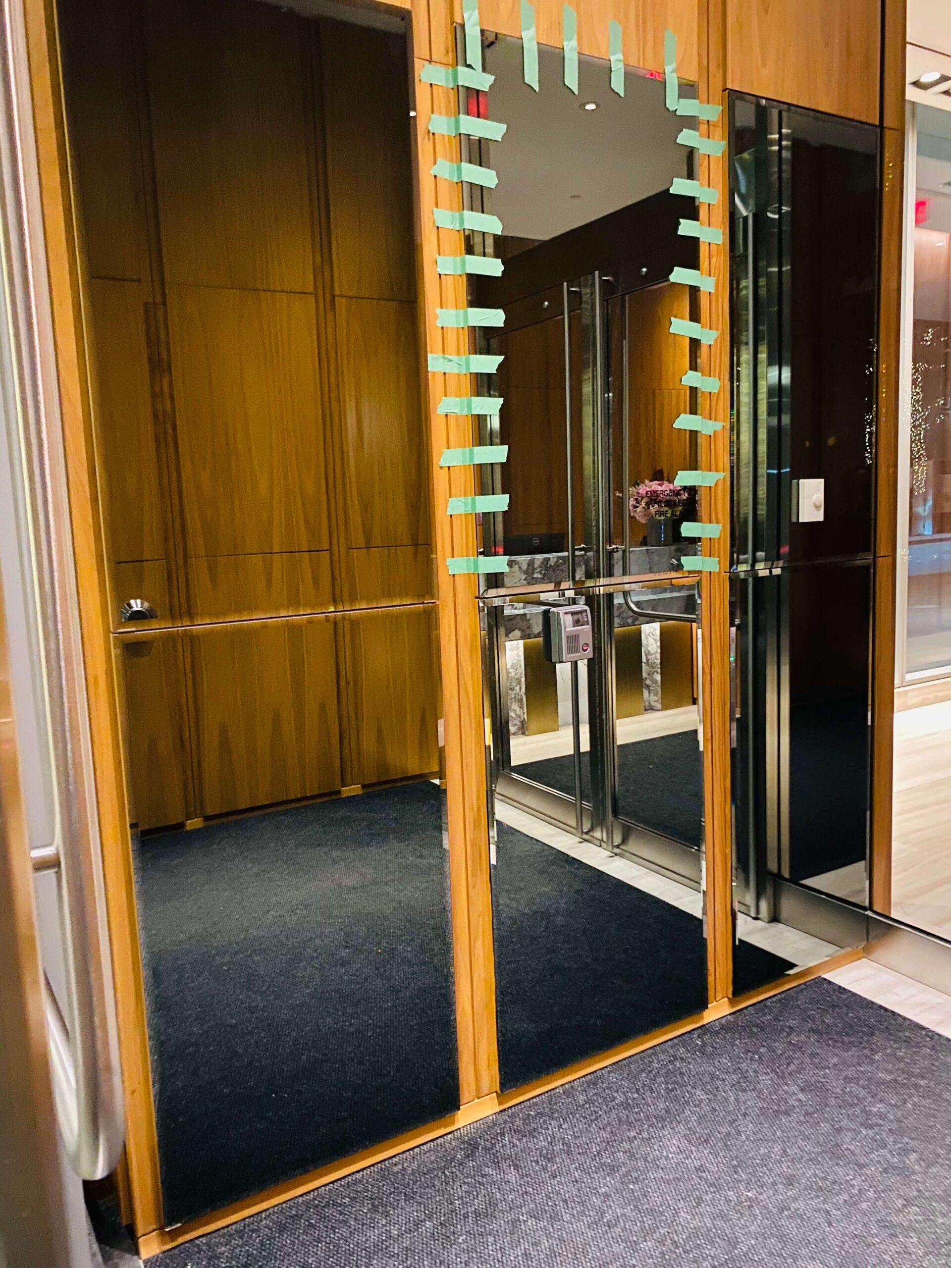 Custom luxury mirror wall installation enhancing natural lighting and space