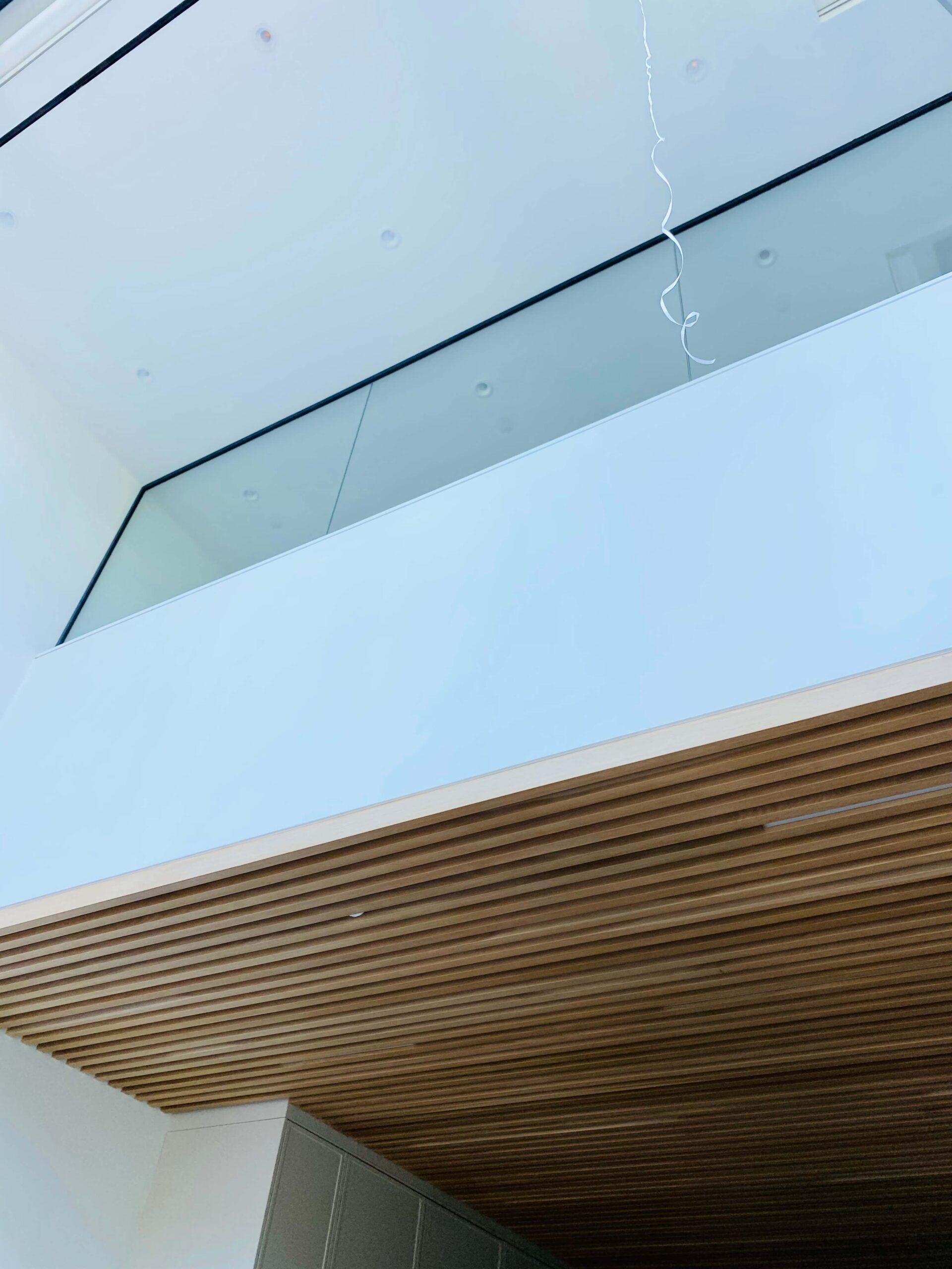 Exterior frameless glass railing system on modern residential balcony
