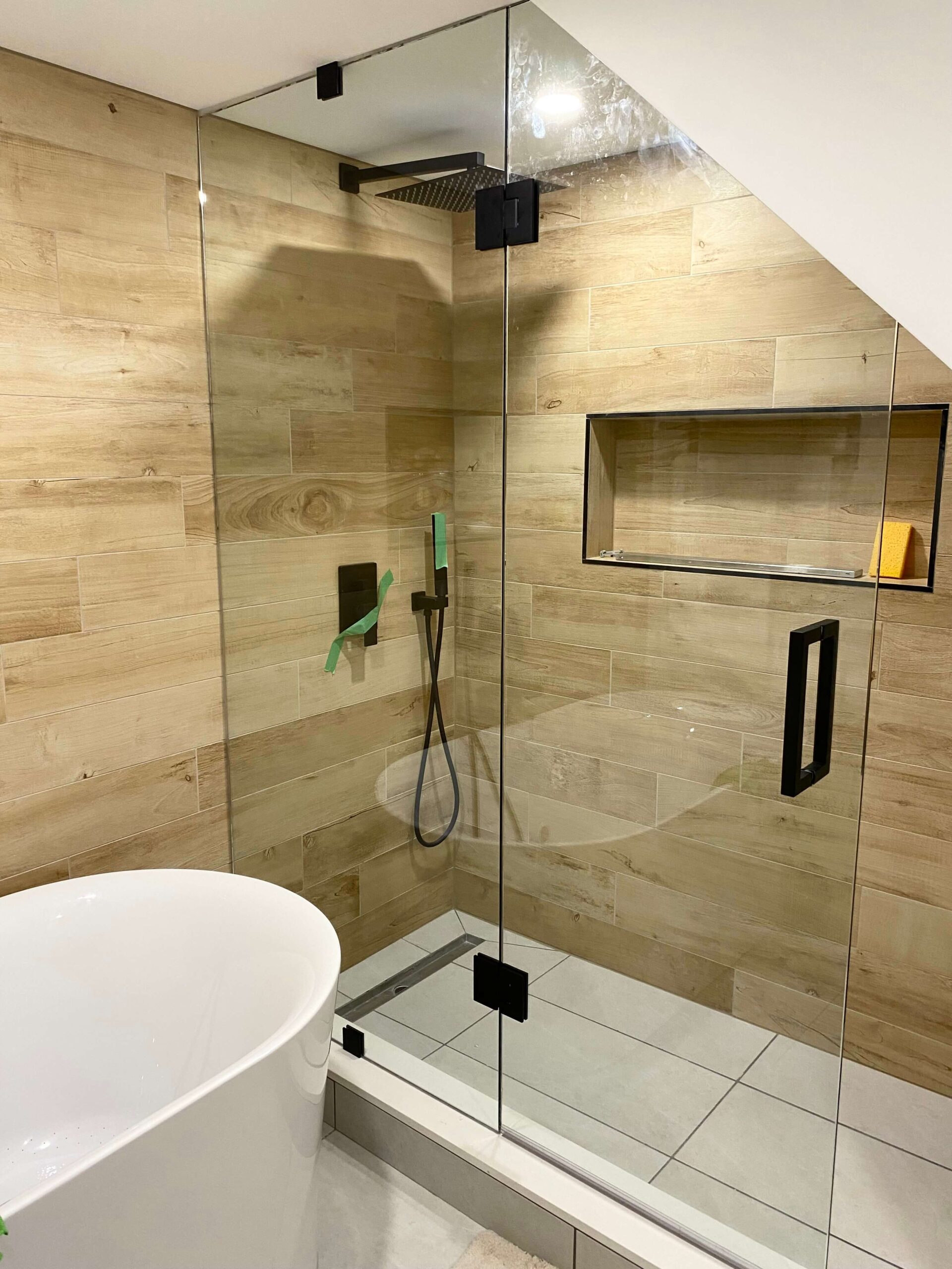 Frameless glass walk-in shower with custom-fitted premium hardware